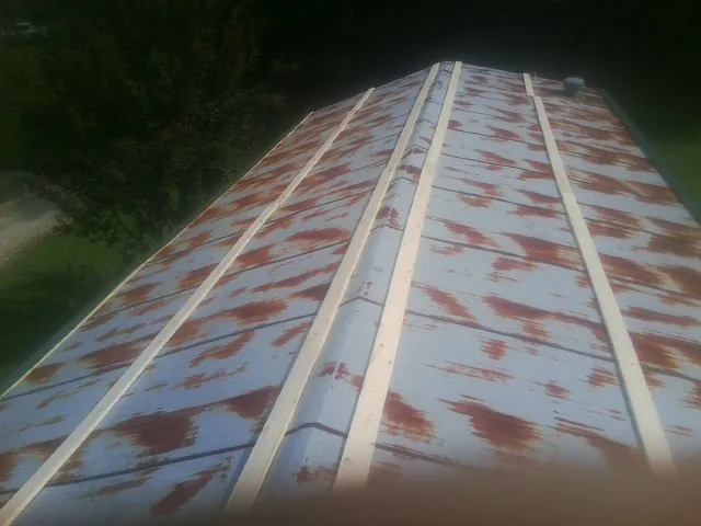 Rusted metal roof panels with new wood purlins before replacement — Storm Damage Roof Repair in Pitman by Roofing Brothers